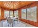 Cozy dining room with wood paneled walls and ceiling plus contemporary furniture and ample natural light at 1032 Tower Blvd, Lake Wales, FL 33853