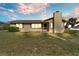 Charming single-story home featuring a front yard with blue shutters, inviting entrance and a tan exterior at 1032 Tower Blvd, Lake Wales, FL 33853