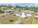 Aerial view of a single story home with mature trees and lawns in a residential neighborhood at 1032 Tower Blvd, Lake Wales, FL 33853