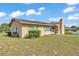 A single story home with a chimney and front yard surrounded by a green lawn at 1032 Tower Blvd, Lake Wales, FL 33853