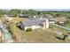 Aerial view of the front of a single story home surrounded by a grassy yard and trees at 1032 Tower Blvd, Lake Wales, FL 33853