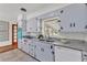 Bright kitchen featuring white cabinets, granite counters, stainless steel sink, and white appliances at 1032 Tower Blvd, Lake Wales, FL 33853
