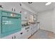 Close up shot of white kitchen featuring vintage turquoise oven, white cabinetry and neutral backsplash at 1032 Tower Blvd, Lake Wales, FL 33853