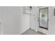 Bright laundry room area with white walls, utility sink, and convenient exterior access at 1032 Tower Blvd, Lake Wales, FL 33853