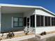 Charming home exterior featuring a screened-in porch with stone landscaping at 11 Navel Dr, Winter Haven, FL 33884