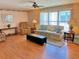 Inviting living room with floral sofa, wood floors, and lots of natural light at 11 Navel Dr, Winter Haven, FL 33884
