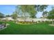 Beautiful backyard with a well-maintained lawn, mature trees, and manicured garden beds at 1162 E Highland Dr, Lakeland, FL 33813