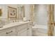Elegant bathroom vanity with stylish fixtures, floral wallpaper, and coordinated shower curtain at 1162 E Highland Dr, Lakeland, FL 33813