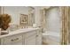 Bright bathroom with a sink, framed mirror, designer wallpaper, and a bathtub with shower at 1162 E Highland Dr, Lakeland, FL 33813