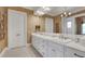 Elegant bathroom featuring double sinks, white cabinetry, and a well-lit vanity area at 1162 E Highland Dr, Lakeland, FL 33813