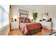 Comfortable bedroom featuring a cozy bed, bedside tables, and a well-lit interior at 1162 E Highland Dr, Lakeland, FL 33813