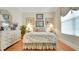 Bright bedroom featuring decorative bedding, light wood floors and matching white dresser at 1162 E Highland Dr, Lakeland, FL 33813
