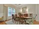 Traditional dining room featuring an ornate chandelier, ample seating, and large window at 1162 E Highland Dr, Lakeland, FL 33813