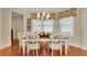 Formal dining room showcasing a decorative light fixture and views of the beautifully landscaped yard at 1162 E Highland Dr, Lakeland, FL 33813