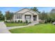 Charming single-story home featuring a welcoming front porch, manicured lawn, and beautiful landscaping at 1162 E Highland Dr, Lakeland, FL 33813