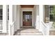 Elegant front door with glass panels, framed by white columns and a wood ceiling at 1162 E Highland Dr, Lakeland, FL 33813