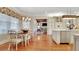 Bright, eat-in kitchen featuring modern cabinetry, stainless steel appliances, and hardwood flooring at 1162 E Highland Dr, Lakeland, FL 33813