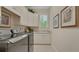 Well-equipped laundry room with modern washer and dryer, sleek countertops, and ample cabinet space at 1162 E Highland Dr, Lakeland, FL 33813