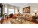 Cozy living room featuring large windows, a decorative rug, and ample seating at 1162 E Highland Dr, Lakeland, FL 33813