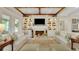 Bright living room with a fireplace, custom built-ins, and stylish furnishings at 1162 E Highland Dr, Lakeland, FL 33813