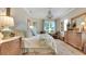 Elegant main bedroom with a decorative chandelier, large windows, and sophisticated furnishings at 1162 E Highland Dr, Lakeland, FL 33813