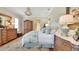 Serene main bedroom featuring a luxurious bed, a decorative chandelier, and a large armoire at 1162 E Highland Dr, Lakeland, FL 33813