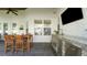 Spacious patio featuring an outdoor kitchen, a dining table, and a mounted TV at 1162 E Highland Dr, Lakeland, FL 33813