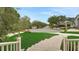 Serene street view showcasing well-maintained lawns, mature trees, and sidewalk at 1162 E Highland Dr, Lakeland, FL 33813