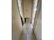Hallway with tile flooring and openings to other rooms, showing access and flow within the home at 128 11Th Wahneta W St, Winter Haven, FL 33880