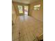 Empty living room with beige tile flooring, a front door, and two windows providing natural light at 128 11Th Wahneta W St, Winter Haven, FL 33880