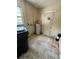 Utility room equipped with a water heater, window, and ample space, with a door leading outside at 128 11Th Wahneta W St, Winter Haven, FL 33880