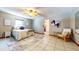 Comfortable bedroom with tile flooring, ceiling fan and a cozy chair next to a small window at 1432 Libby Rd, Babson Park, FL 33827