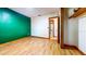 Bright bedroom featuring hardwood floors, neutral-tone walls, and an open closet space at 1432 Libby Rd, Babson Park, FL 33827