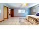 Open bedroom with hardwood floor, white quilt on bed and open door to another room at 1432 Libby Rd, Babson Park, FL 33827