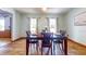 Inviting dining room with wood floors and a dining table for four, illuminated by soft natural light at 1432 Libby Rd, Babson Park, FL 33827