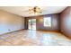 Living room with tile floors, sliding glass door, and a large window at 1432 Libby Rd, Babson Park, FL 33827