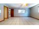 Bright living room featuring tile floors, neutral paint scheme, and a connecting door at 1432 Libby Rd, Babson Park, FL 33827