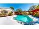 This backyard features a sparkling swimming pool and a covered outdoor living space at 1432 Libby Rd, Babson Park, FL 33827