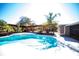 Refreshing swimming pool with deck, landscaping, and an overhead trellis in the backyard at 1432 Libby Rd, Babson Park, FL 33827