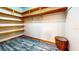 Spacious walk-in closet with wood shelving and modern vinyl plank floors at 1432 Libby Rd, Babson Park, FL 33827
