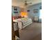 Cozy bedroom features nautical decor, quilt, and ceiling fan at 148 Sweet Cir, Winter Haven, FL 33884