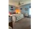 Comfortable bedroom with ceiling fan, bed with nautical-themed quilt, and decorative accents at 148 Sweet Cir, Winter Haven, FL 33884