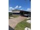 View of the home's exterior with a driveway and carport, showcasing its curb appeal at 148 Sweet Cir, Winter Haven, FL 33884