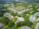 Overview of a large condo community, showcasing lush green trees, a pond, and multiple residential buildings at 1503 Eagle Pond Dr # 1503, Winter Haven, FL 33884