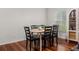 Cozy dining area featuring a wooden table with six chairs, hardwood floors, and natural light, great for gatherings at 1503 Eagle Pond Dr # 1503, Winter Haven, FL 33884