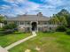 Beautiful condo building featuring lush landscaping, neutral paint scheme, and a welcoming pathway at 1503 Eagle Pond Dr # 1503, Winter Haven, FL 33884