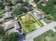 Overhead view of home with mature trees with white border at 1506 Chamberlain Loop, Lake Wales, FL 33853