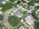 An aerial view showcasing neighborhood homes with fenced yards and mature trees on a clear day at 1506 Chamberlain Loop, Lake Wales, FL 33853