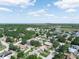 Scenic aerial view of a peaceful residential community with mature trees and a distant lake at 1506 Chamberlain Loop, Lake Wales, FL 33853