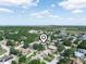 An aerial view of a residential neighborhood with lush green spaces under a blue sky at 1506 Chamberlain Loop, Lake Wales, FL 33853